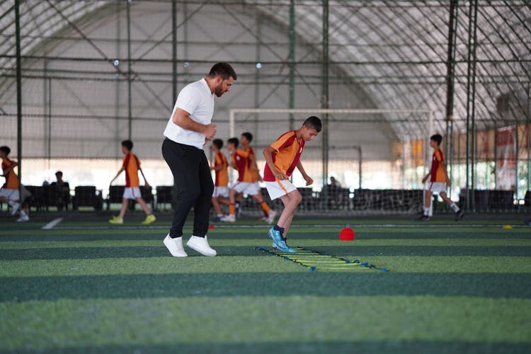 Coach running soccer drills at practice.